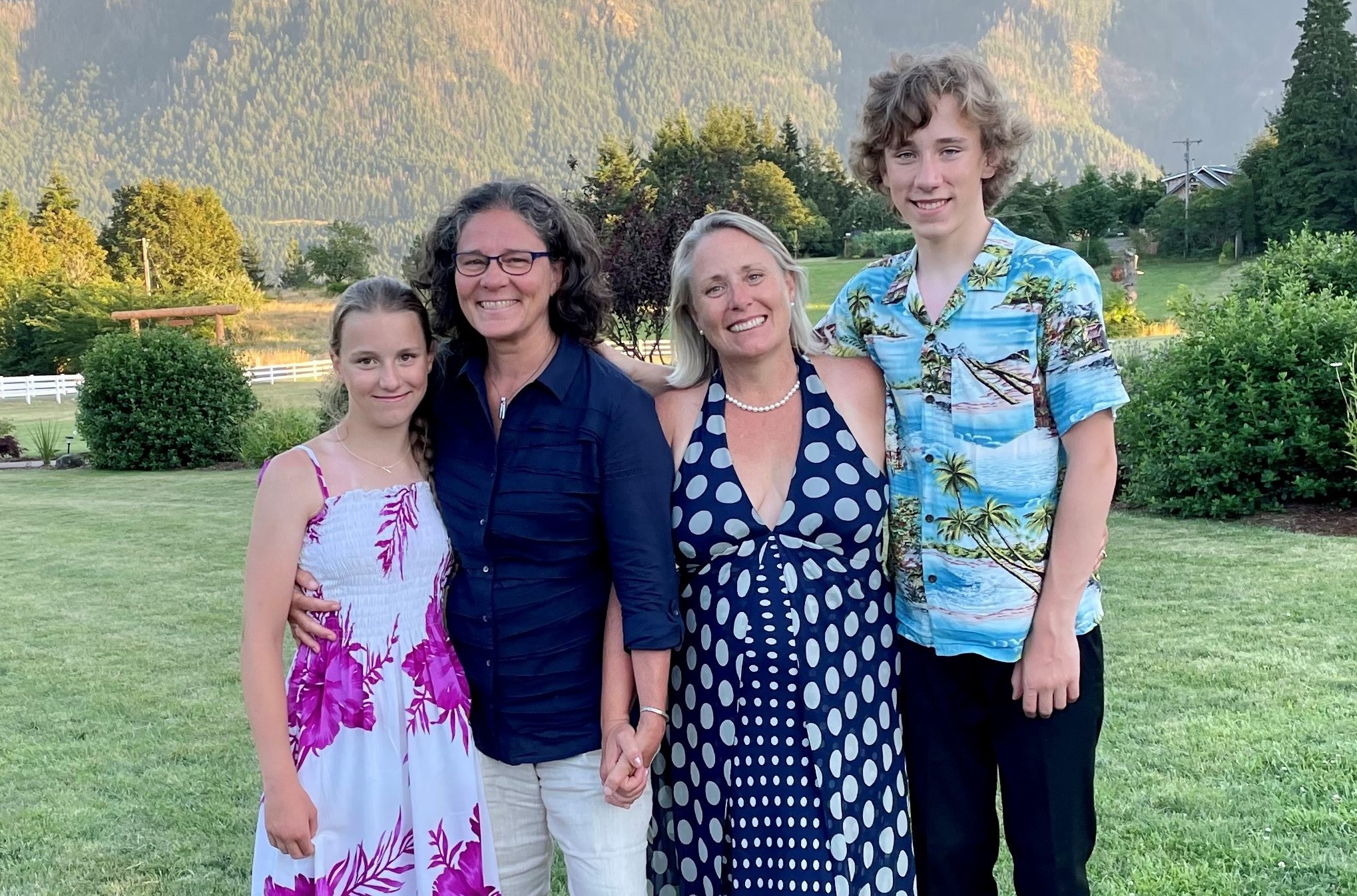 A photo of Dr. Mithya Lewis-Newby, MD, MPH, with her wife and children.