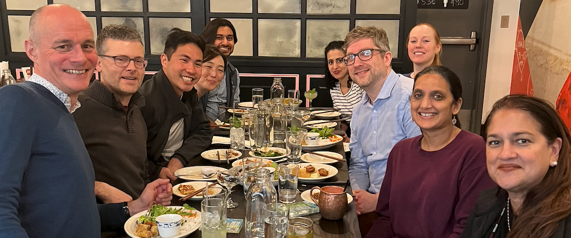 Infectious Disease Faculty and Fellows smiling for the camera at a restaurant