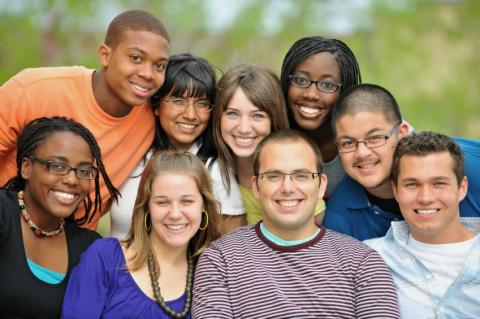 A diverse group of teens, smiling for the camera