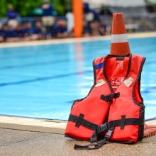 Life jacket placed infront of a pool. 